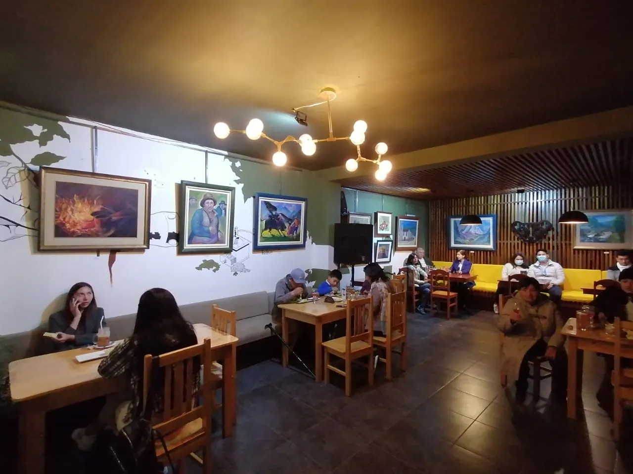La sala de Luwak con los cuadros en las paredes y el público en las mesas